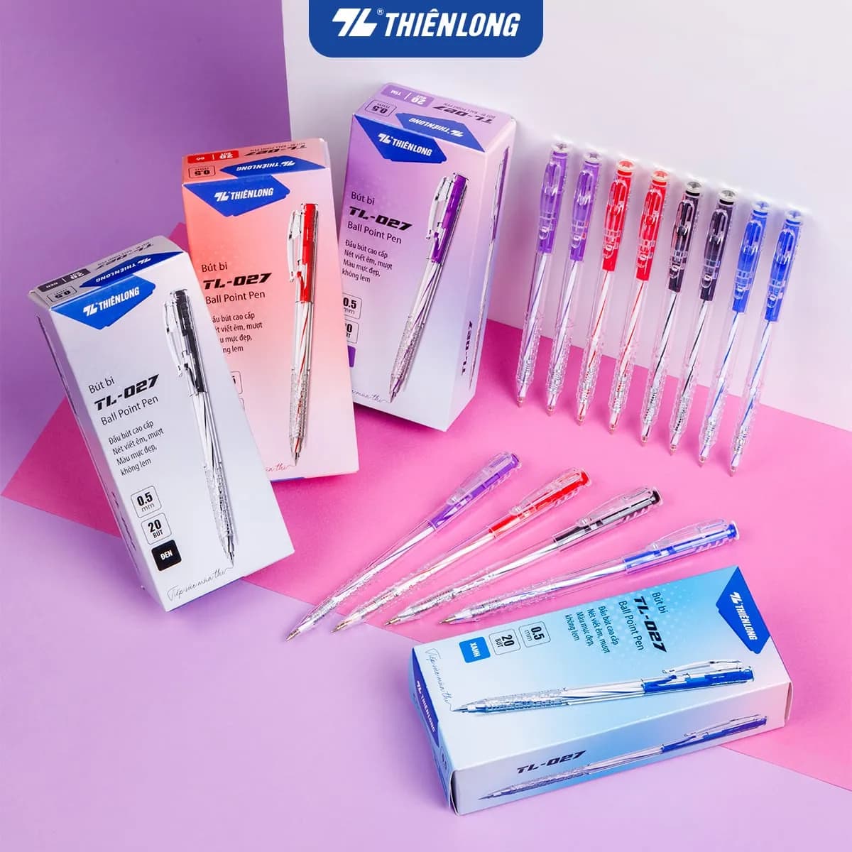 bút bi thiên long TL-027 với các hộp và cây bút nhiều màu sắc đặt trên nền hồng tím.